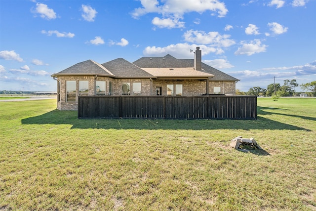 back of house featuring a yard