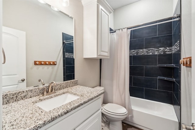 full bathroom with vanity, shower / tub combo, and toilet