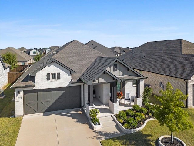 view of front of property featuring a garage and a front yard