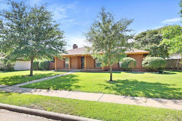 ranch-style home featuring a front yard