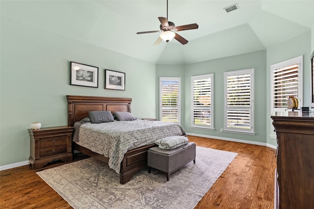 bedroom with ceiling fan, lofted ceiling, and dark wood-type flooring