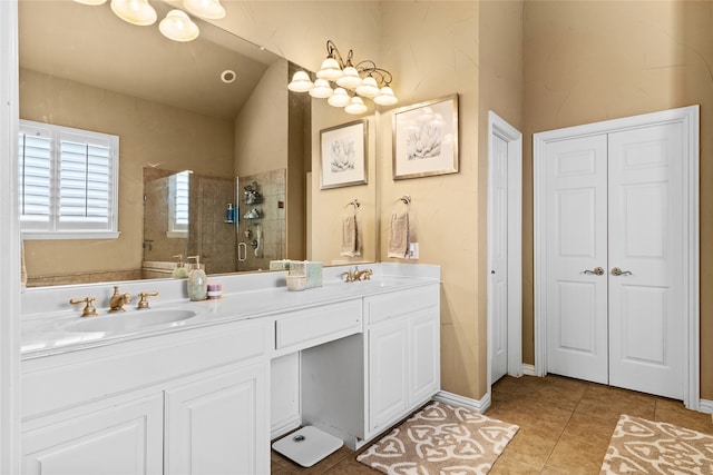 bathroom with tile patterned flooring, a shower with door, and vanity