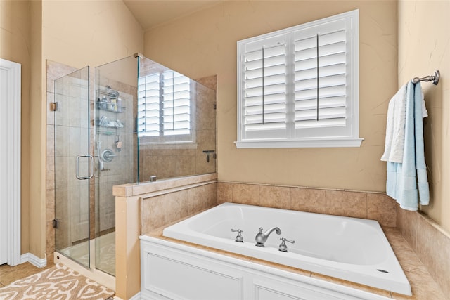 bathroom featuring shower with separate bathtub