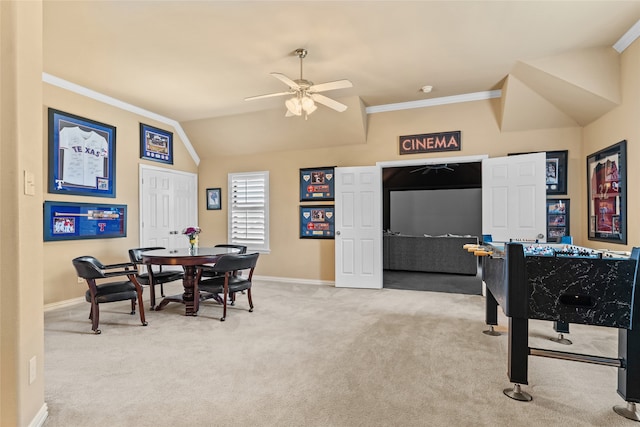 recreation room with ceiling fan, light colored carpet, crown molding, and vaulted ceiling