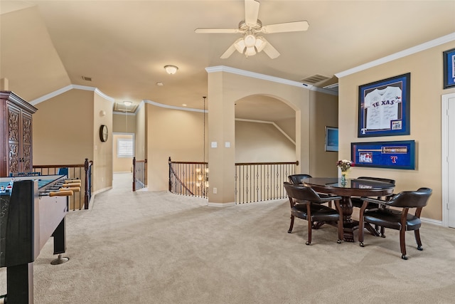 dining space featuring ornamental molding, ceiling fan, and light carpet