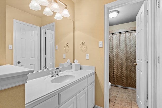 bathroom with vanity, tile patterned flooring, and toilet