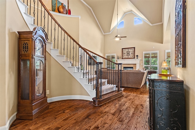 entryway featuring ceiling fan, hardwood / wood-style floors, and high vaulted ceiling