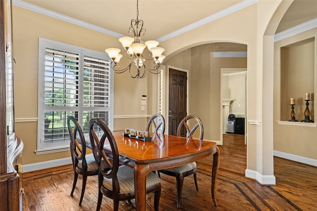 dining area with ornamental molding, hardwood / wood-style floors, and a chandelier