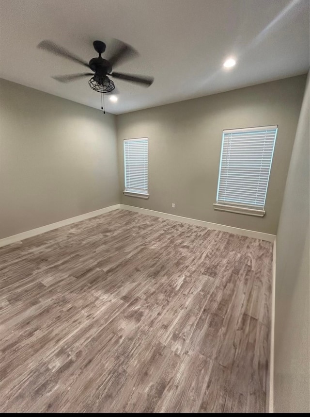 spare room with ceiling fan and wood-type flooring