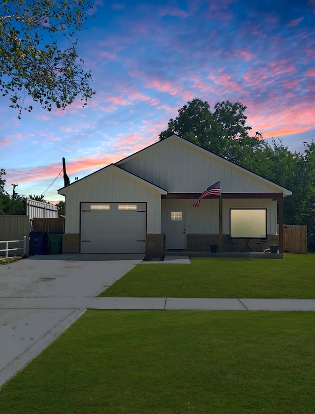 view of front of property featuring a lawn and a garage