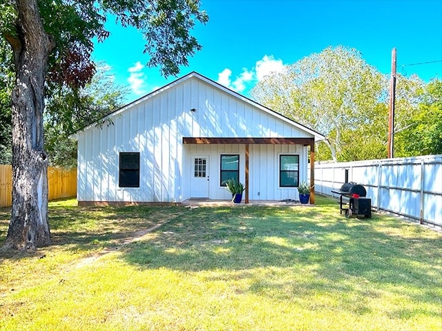 back of property with a yard