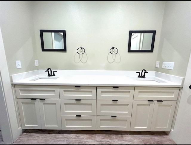 bathroom featuring vanity and hardwood / wood-style floors