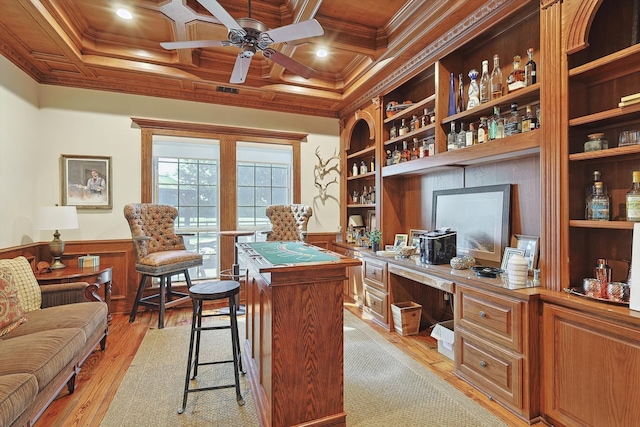 home office featuring ceiling fan, ornamental molding, light hardwood / wood-style flooring, built in desk, and coffered ceiling