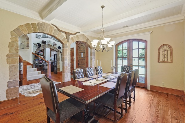 dining area featuring ornamental molding, beamed ceiling, a chandelier, and hardwood / wood-style floors