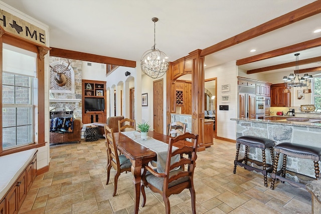 dining area featuring beam ceiling and a chandelier