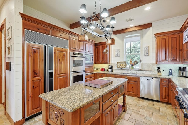 kitchen with beamed ceiling, a center island, hanging light fixtures, an inviting chandelier, and stainless steel appliances