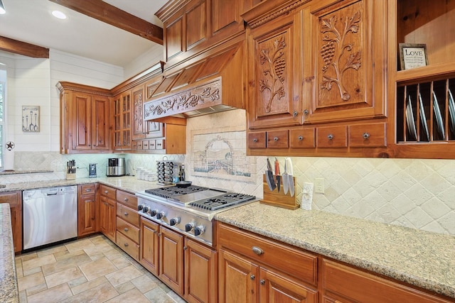 kitchen with light stone counters, appliances with stainless steel finishes, custom range hood, and tasteful backsplash