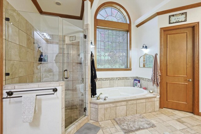 bathroom with ornamental molding and shower with separate bathtub