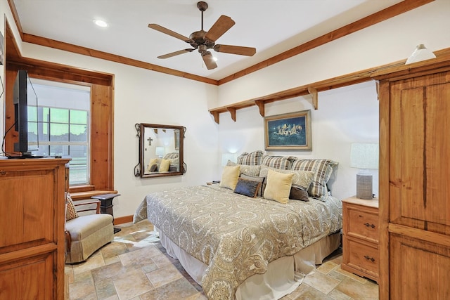 bedroom with ornamental molding and ceiling fan