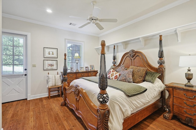 bedroom with crown molding, hardwood / wood-style floors, and ceiling fan