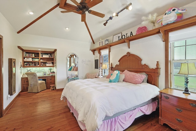 bedroom featuring lofted ceiling, hardwood / wood-style floors, and ceiling fan