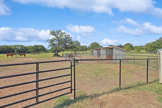 view of yard with a rural view and an outbuilding