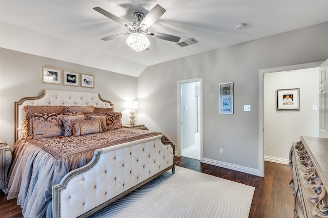 bedroom featuring lofted ceiling, dark hardwood / wood-style flooring, and ceiling fan