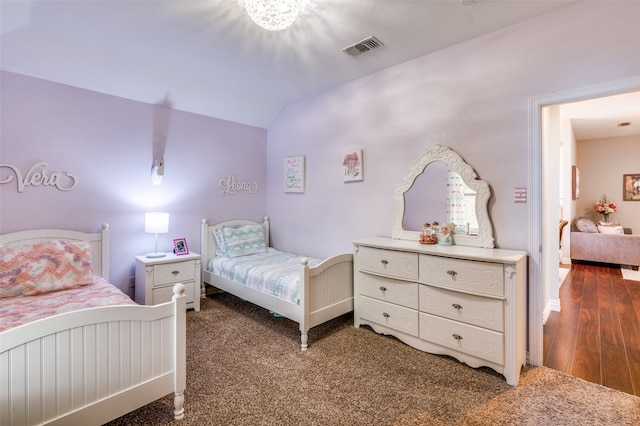 bedroom featuring vaulted ceiling and dark hardwood / wood-style flooring