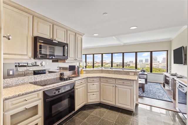 kitchen featuring cream cabinetry, black appliances, light stone countertops, crown molding, and dark hardwood / wood-style flooring