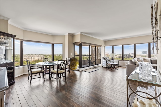 dining area with ornamental molding, dark hardwood / wood-style floors, and a wealth of natural light