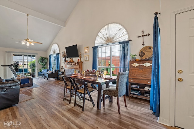 dining space with hardwood / wood-style flooring, high vaulted ceiling, ceiling fan, and beamed ceiling