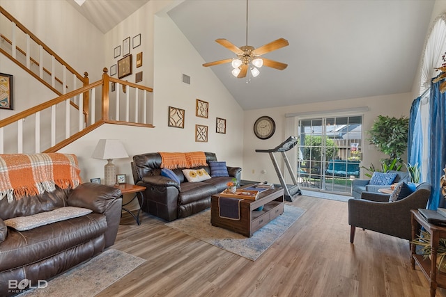 living room with hardwood / wood-style flooring, high vaulted ceiling, and ceiling fan