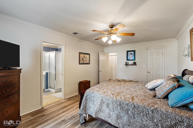 bedroom featuring ceiling fan, ornamental molding, ensuite bath, and hardwood / wood-style floors