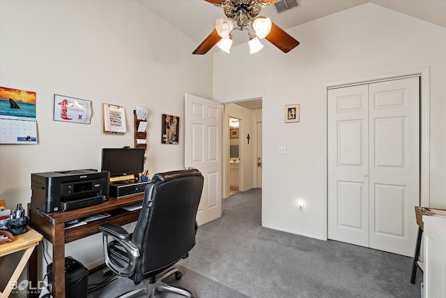 carpeted office space with ceiling fan and high vaulted ceiling