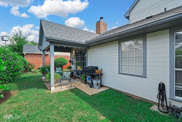 back of house featuring a lawn and a patio area