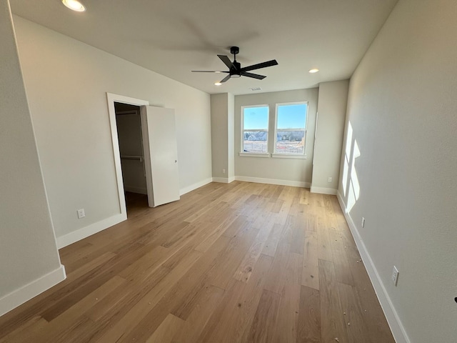 empty room featuring ceiling fan and light wood-type flooring