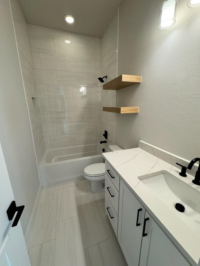 full bathroom with tiled shower / bath combo, vanity, and toilet