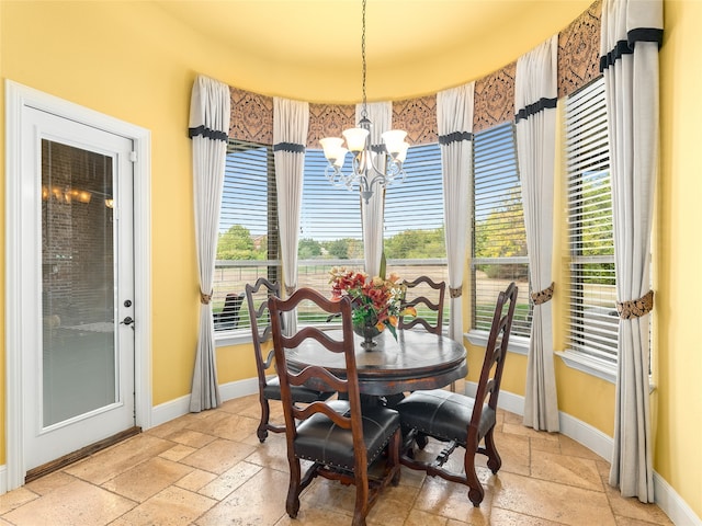 dining space featuring a notable chandelier and a healthy amount of sunlight