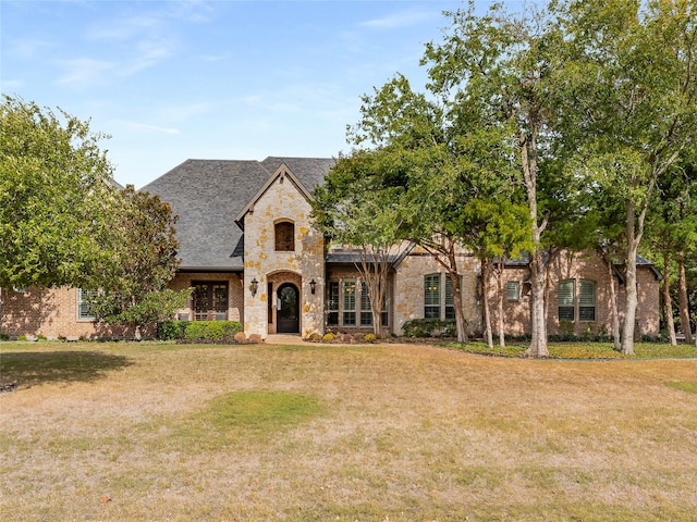 french provincial home with a front lawn