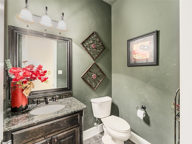 bathroom featuring vanity, toilet, and tile patterned flooring