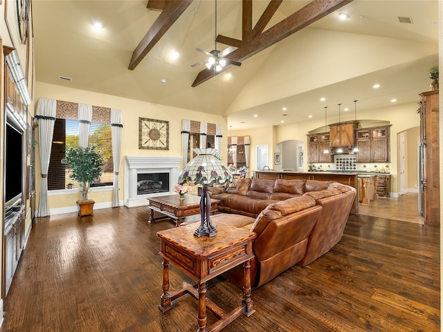 living room featuring beamed ceiling, dark hardwood / wood-style floors, high vaulted ceiling, and ceiling fan