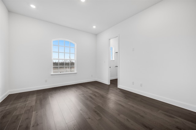 unfurnished room with dark wood-style floors, baseboards, and recessed lighting