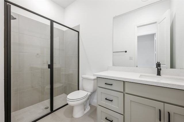 bathroom with toilet, a shower stall, vanity, and tile patterned floors