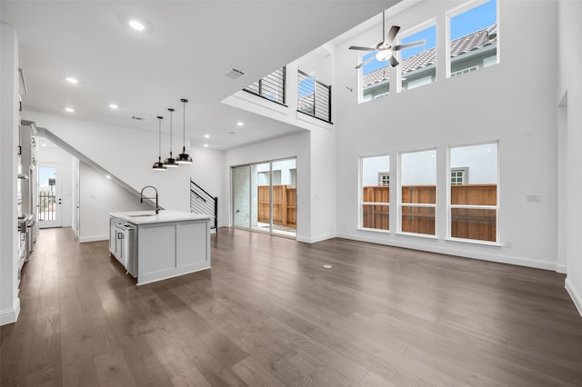 interior space featuring visible vents, stairway, dark wood-style flooring, a sink, and recessed lighting