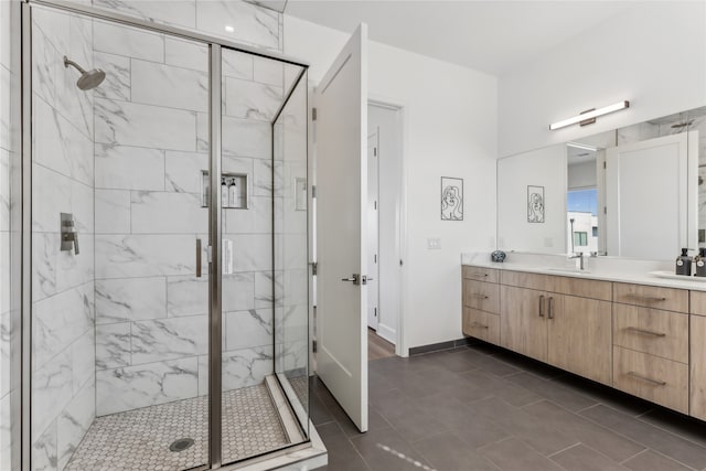 bathroom with vanity, a shower with shower door, and tile patterned floors