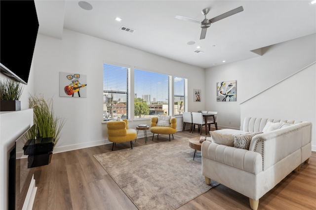 living room with hardwood / wood-style flooring and ceiling fan