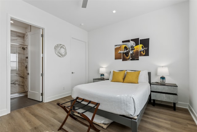 bedroom featuring dark hardwood / wood-style flooring, connected bathroom, and ceiling fan