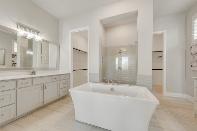 bathroom featuring vanity, separate shower and tub, and tile patterned floors