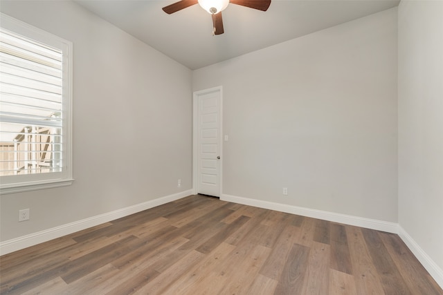 unfurnished room with ceiling fan and hardwood / wood-style flooring