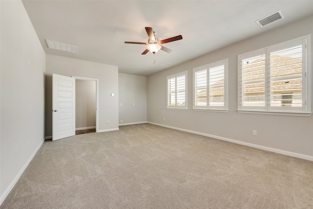 unfurnished room featuring light carpet and ceiling fan